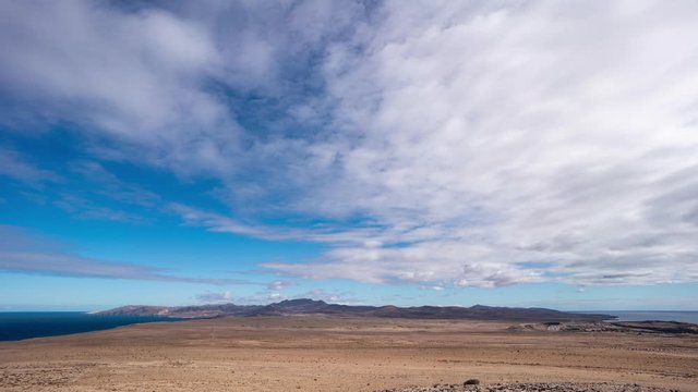 Clouds flying over the desert volcanic landscape of Fuerteventura. Costa Calma, Canary Islands