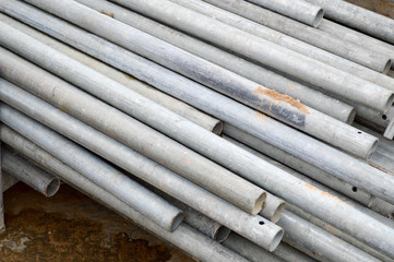 Fototapeta premium Large iron metal sewer plumbing pipes of large diameter for the industrial construction of water supply or sewage at a construction site during the repair