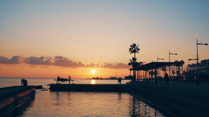 Fototapeta premium Paphos, Cyprus tropical resort embankment at beautiful colorful sunset. Mediterranean vacations and travel concept, copy space
