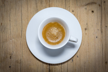 top view a cup of espresso coffee on wooden table background