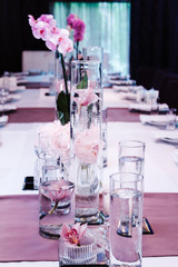 Serving tables in a restaurant with peonies and orchids