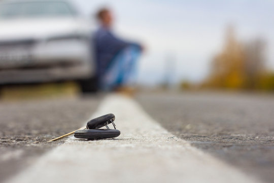 lost car keys lying on the roadway, on a blurred background with bokeh effect