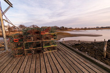 Fototapeta na wymiar Lobster traps on the wharf during sunset - Biddeford Pool Harbor, Maine.