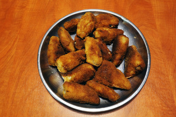 Roast chicken wings on a metal plate
