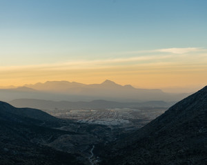 sunset view with mountains and city in background