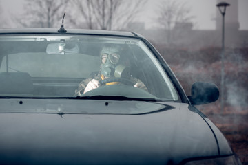 Fototapeta na wymiar soldier driving a car with gas mask