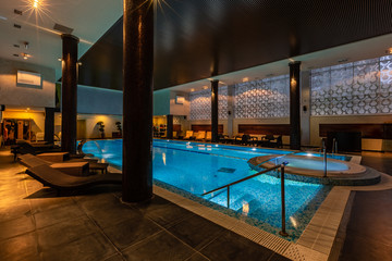 Fototapeta premium Modern blue on light backdrop. Trendy design. Water - swimming pool. Blue luxurious swimming pool in modern style on light background. Water - swimming pool. Modern design. Night club. Trendy design.