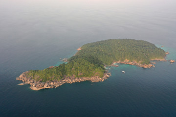 Tropical island and scuba diving liveaboard boat. Aerial photo 