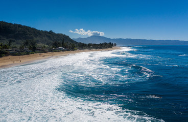 Surfers waiting for the big wave in the sea at Banzai Pipeline on north coast of Oahu, Hawaii