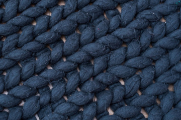 Wool on a plaid after a cat or dog and waste. Texture of blue big knit blanket. Large knitting. Plaid merino wool. Top view