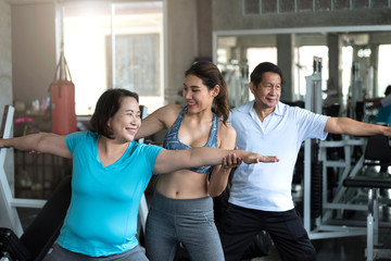Fototapeta na wymiar Group of friend asian senior stretching exercise at yoga gym. elderly healthy lifestyle.
