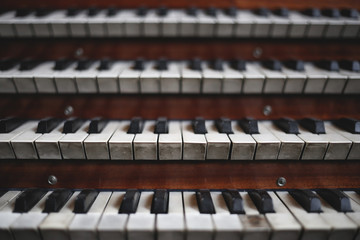 Keys on a big old brown church organ