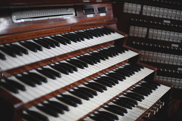 Keys and buttons on a big old brown church organ