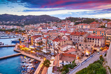 View from the walls of the citadel of Calvi on the old town with historic buildings at evening...