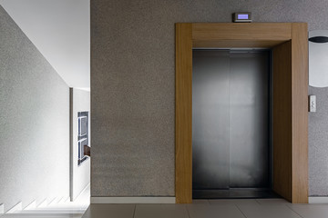 Luxury lifestyle design. Modern interior design. Modern steel elevator. Stairs. Nobody inside.