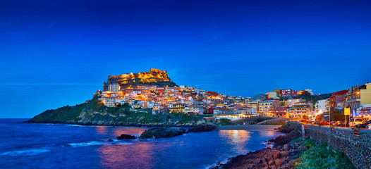 Beautiful panoramic view of Medieval town of Castelsardo at evening (night), Province of Sassari, Sardinia, Italy, Europe. Colorful photo of gorgeous italian town. Popular travel destination. Postcard