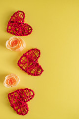 Red hearts and flowers on a yellow background, design postcard for Valentine's Day.