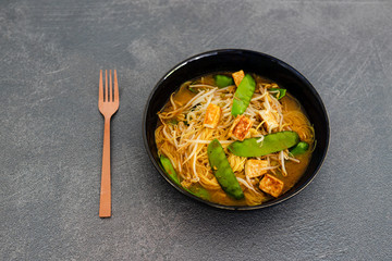 vegan laksa noodle soup with snowpeas and tofu