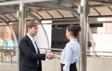 Two businessman and businesswoman manager start up is shaking hand talk discuss about agreement cooperation negotiation partnership marketing management digital support professional