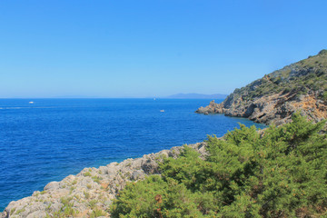 Fototapeta na wymiar View of Tirrenic sea with rocks and vegetation. Monte Argentario, Tuscany, Italy