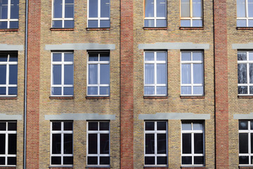 Facade of an old brick factory building with a window front in Augsburg / Germany