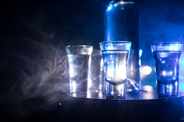 Vodka in bar on a glass table, focus on glass. Club drink concept.