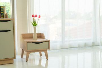 tulip in vase on wooden table decoration in a room