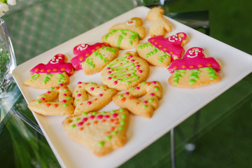 New Year's treats. New Year cookies in the form of men lie on a white plate