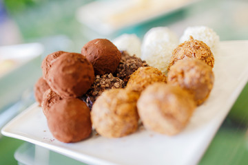 New Year's treats. New Year's cookies and macrons lie on a white plate.