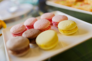 New Year's treats. New Year's cookies and macrons lie on a white plate.