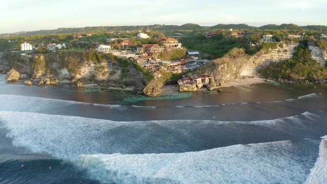Parallax aerial view of the famous surfer spot Suluban Beach during sunset, Uluwatu Bali Indonesia
