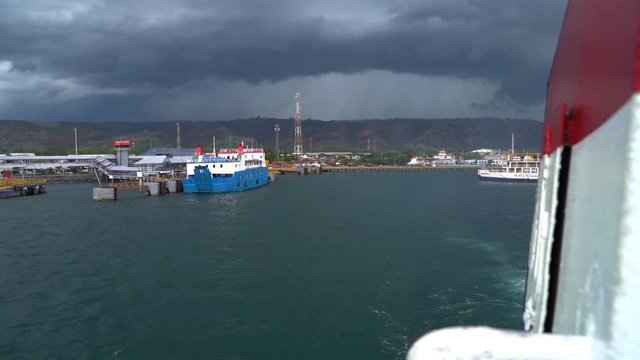 Slow motion view looking back as passenger ferry departs from East Java headed to West Bali