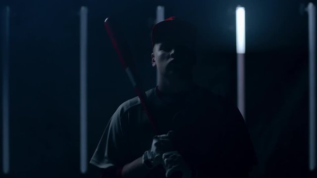 Caucasian professional baseball player batter posing against bright lights. 4K UHD 60 FPS SLOW MOTION shot on ARRI Alexa Mini with Cooke S4 lens