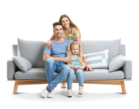 Happy Young Family With Sofa On White Background