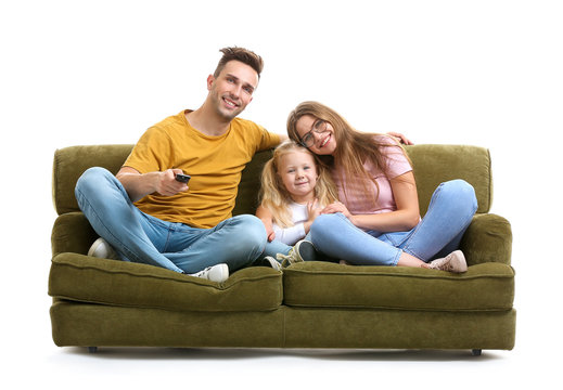 Happy Young Family Watching TV While Sitting On Sofa Against White Background