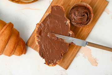 Tasty sweet croissants with chocolate on white background
