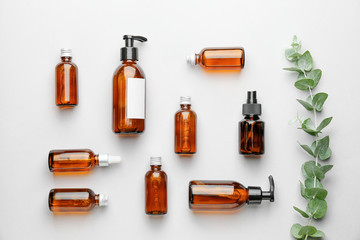 Different cosmetic products in bottles on white background