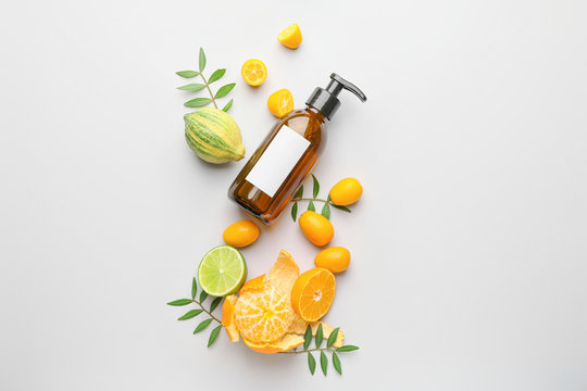 Cosmetic Product In Bottle And Citrus Fruits On White Background