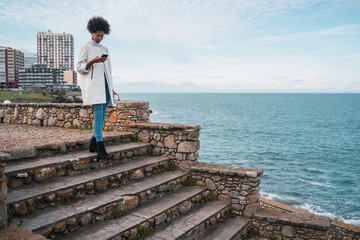 Young woman using her mobile phone.