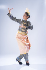 A beautiful Malaysian traditional female dancer performing a cultural dance routine in a...