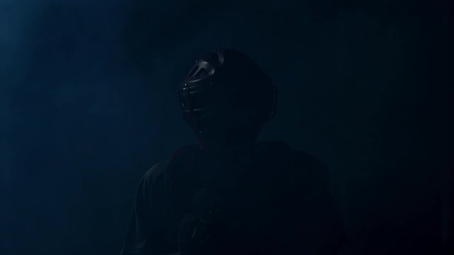 FIXED Caucasian professional baseball player catcher posing against bright lights. 4K UHD 60 FPS SLOW MOTION shot on ARRI Alexa Mini with Cooke S4 lens