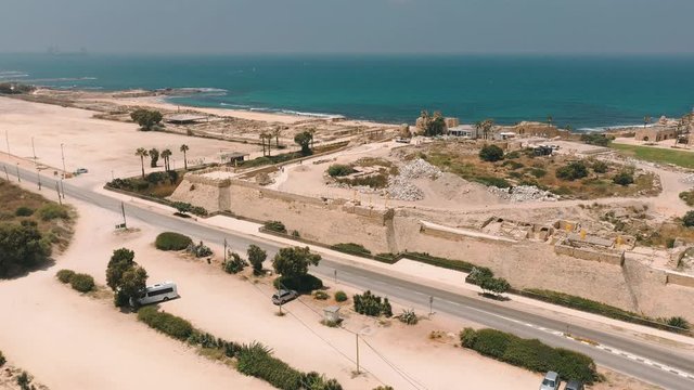 Aerial panorama view of Casarea Maritima, ancient walled city from the Roman, Byzantine and Crusader era with city walls, bastions on the coast of the Mediterranean sea in Israel