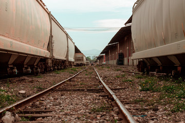 Naklejka na ściany i meble Pantaco. Ciudad de Mexico. Mexico 11/01/2020. train tracks in the middle of warehouses made of bricks