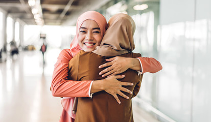 Portrait of happy arabic two friend muslim woman with hijab dress smiling and hugging together