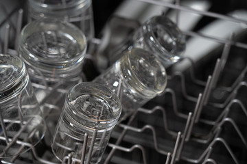 Clear glasses on the top rack of a dishwasher.