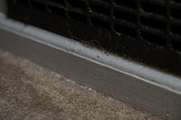 Dust, dirt, and hair accumulate on HVAC return vents and need to be cleaned regularly.