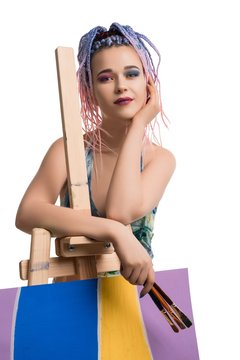 Sexy woman in sportswear near easel view