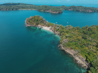 Fototapeta na wymiar aerial drone photo of two big islands with trees at the pacific of Panama with some boats