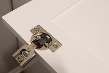 Soft-close concealed cabinet door hinge is installed on the door before being mounted to the cabinet box
