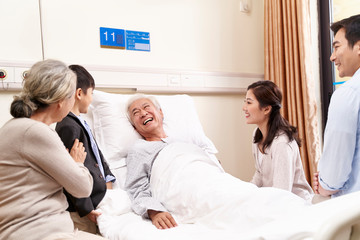 asian couple and son visiting grandfather and grandmother in hospital